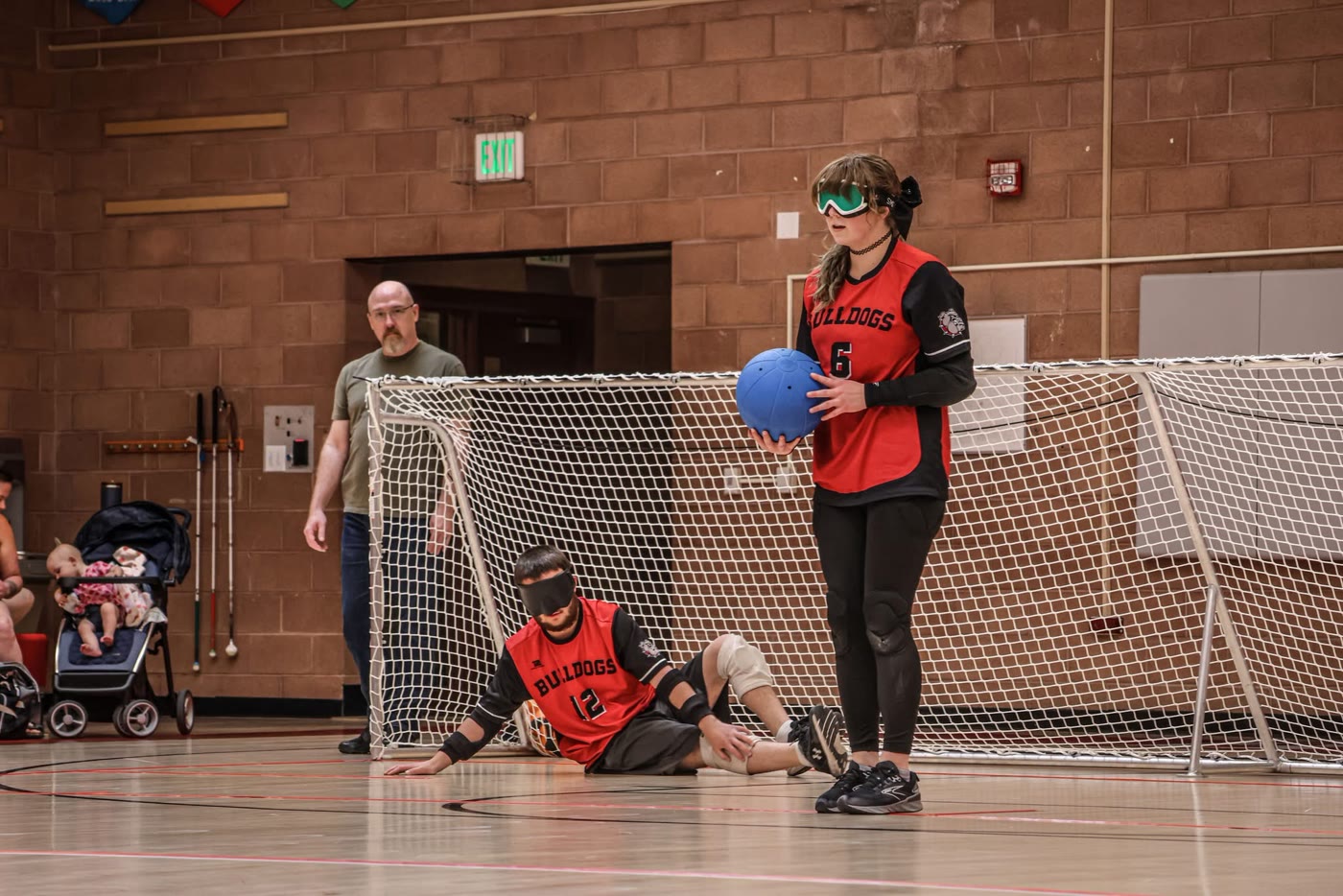 Tayler stands ready with the ball in her red jersey before a throw.
