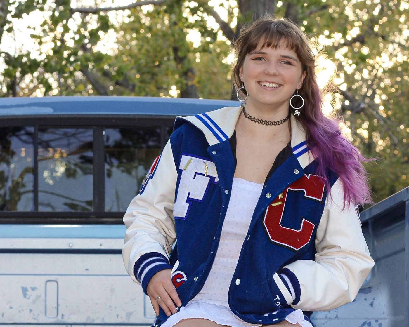 Tayler smiling outdoors with her hair down, ready to take on the world.